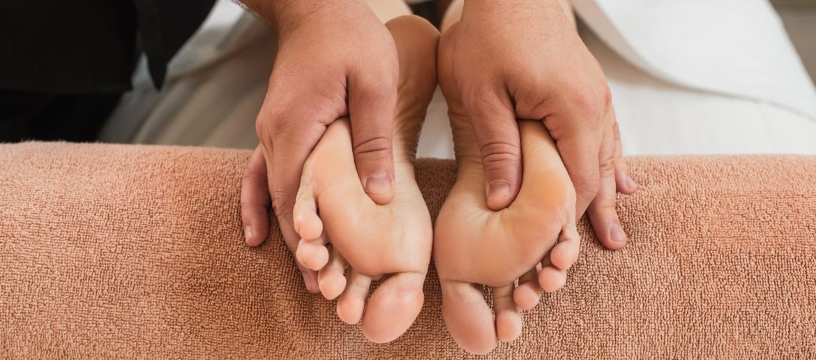 cropped-view-of-masseur-doing-feet-massage-to-woma-2023-11-27-05-22-48-utc